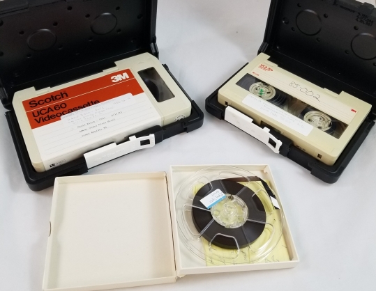 Two U-Matic video cassettes and one small reel-to-reel audio tape